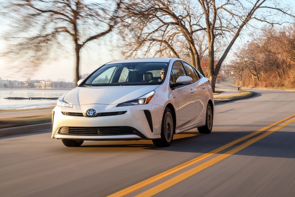 white 2020 toyota prius driving on a road