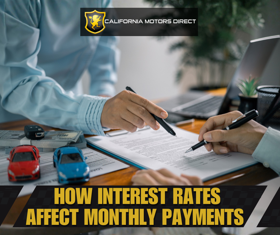 Car buyers reviewing financing paperwork at a desk, illustrating how interest rates affect monthly car payments