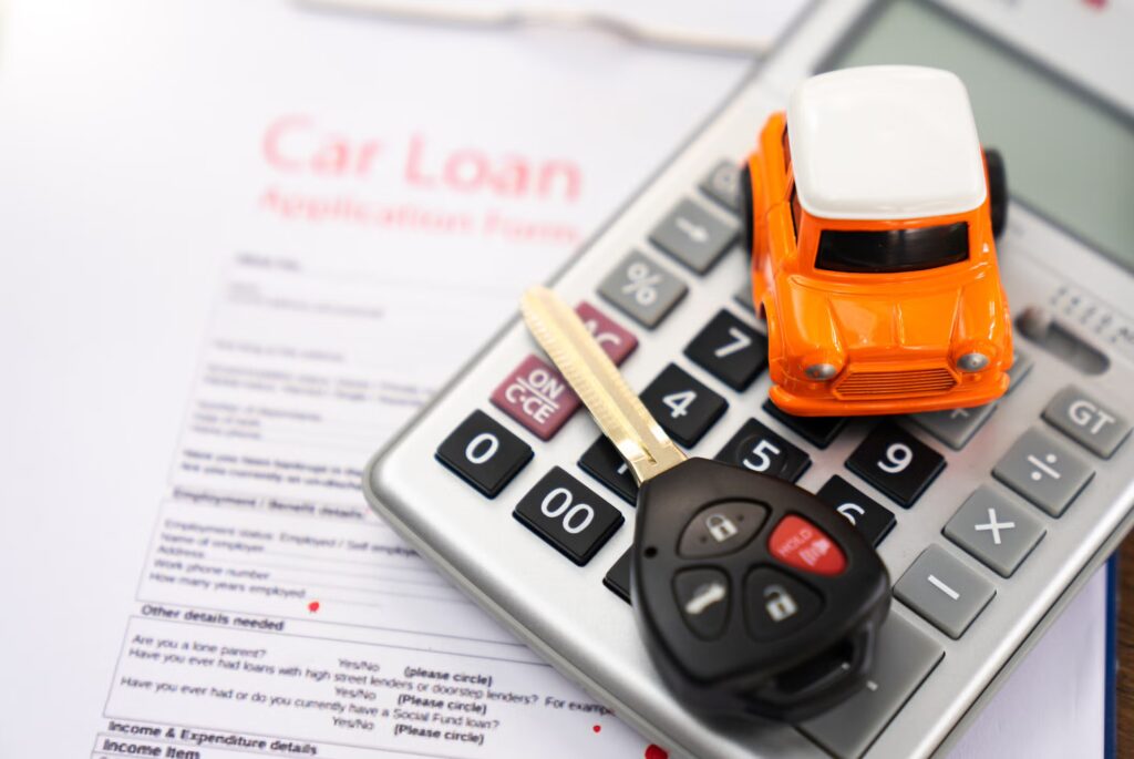 Car loan concept showing a vehicle, calculator, and percentage symbol representing auto loan interest rates and monthly payments.